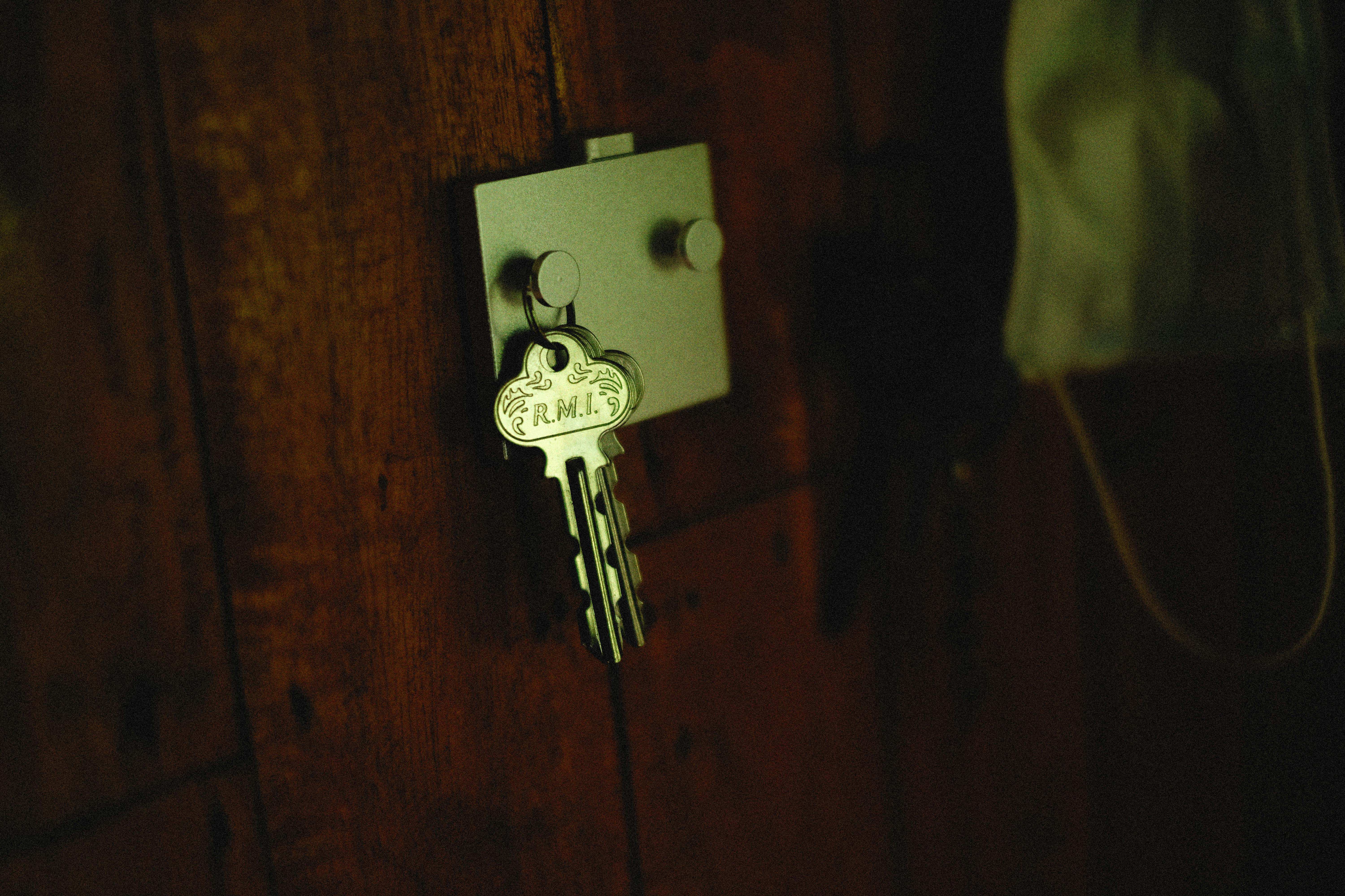 Professional locksmith inserting key into high-security lock
